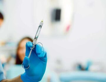 Assistant dentist and the patient in the clinic.